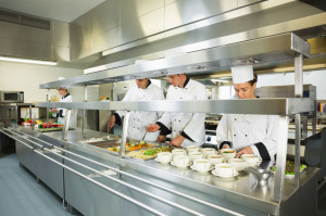 26767862 - four chefs working in a big kitchen at service time