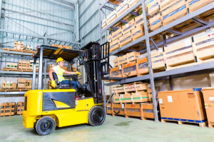 33784454 - asian fork lift truck driver lifting pallet in storage warehouse