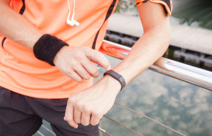 37244964 - close up of guy using wearable fitness gear