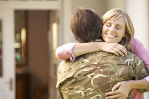 42248320 - soldier returning home and greeted by wife