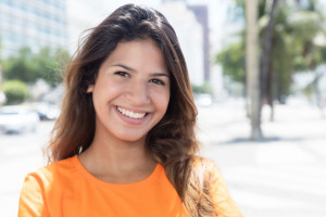 49428928 - beautiful caucasian woman in a orange shirt in the city