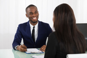 55430077 - male manager interviewing a young female applicant in office