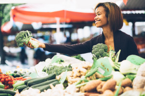 28471654 - young woman buying vegetables at farmers market