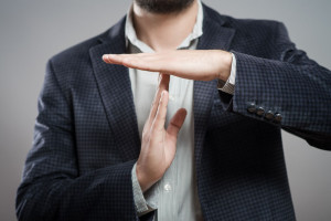 39052362 - young businessman showing time out sign with hands against