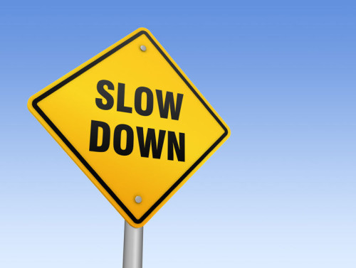 62762876 - slow down road sign 3d concept illustration on sky background