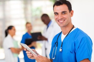 17781908 - handsome medical surgeon with tablet computer in hospital