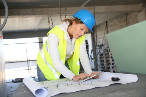 28354270 - woman architect on building site using tablet