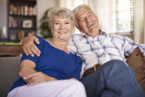 44406077 - happy mature marriage sitting on the sofa