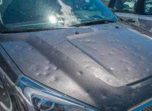 81425547 - hail damage to a car during a big storm