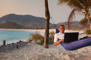 39807311 - man uses laptop remotely at the beach