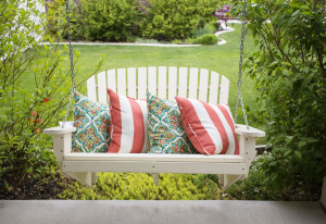 57501590 - beautiful wooden front porch swing with comfortable pillows