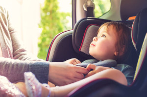 73897173 - toddler girl buckled into her car seat