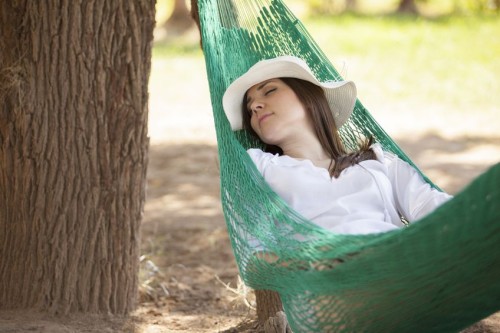 18320543 - gorgeous young woman taking a nap in a hammock outdoors