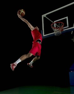 21399225 - basketball game sport player in action isolated on black background