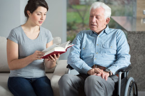 34424889 - senior care assistant reading book elderly man