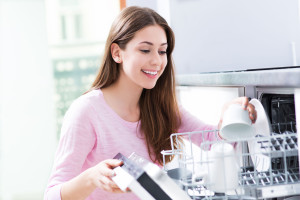 41796616 - woman loading dishwasher