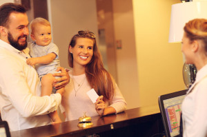 65613841 - picture of family checking in hotel
