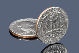97533168 - quarter dollar coins on dark mirror surface