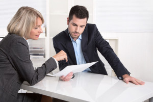 37909742 - business team in a meeting looking at a sheet of paper