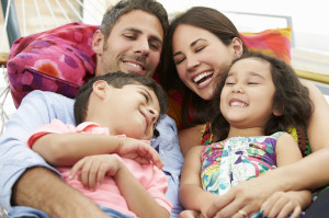 42270875 - family relaxing in garden hammock together