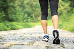 50429401 - young fitness woman walking at forest trail