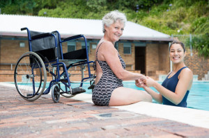 75905023 - portrait of female coach and senior woman smiling at poolside