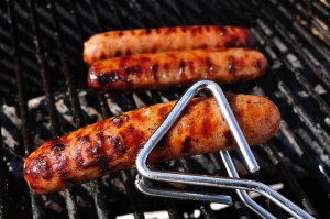6525129 - bratwurst on the grill with tongs, copy space