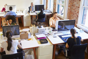 42307744 - wide angle view of busy design office with workers at desks