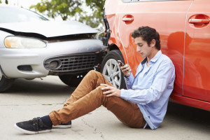 42308955 - teenage driver making phone call after traffic accident