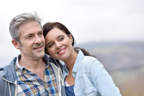 54121090 - cheerful middle-aged couple embracing outside