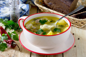 56396705 - soup with dumplings and meat on wooden table, selective focus.