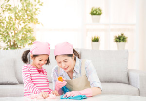 Happy family cleans the living room