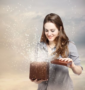 14422794 - happy young woman opening a gift box