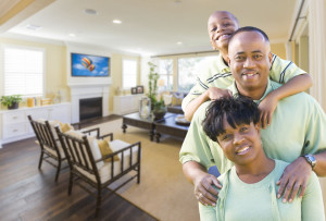 Happy Young African Amercian Family In Their Living Room.