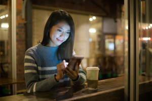 54088599 - woman using cellphone at coffee shop