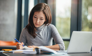 Woman taking down notes in diary