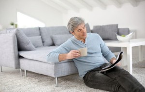 25762925 - senior relaxing at home and reading magazine
