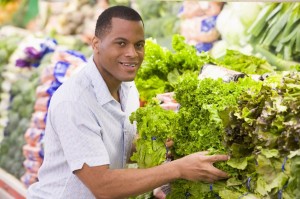 3226271 - man shopping for lettuce at a grocery store