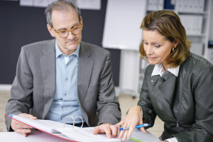 management team discussing papers