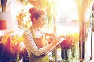 florist woman with clipboard at flower shop