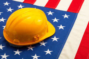 Construction helmet laying over USA flag - closeup shoot