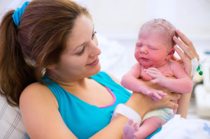 Young mother giving birth to a baby