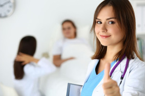 Smiling female medicine doctor holding document pad and showing