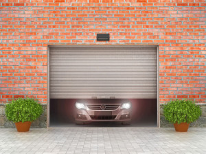 Garage concept. Garage doors are opened, and behind them is a ca