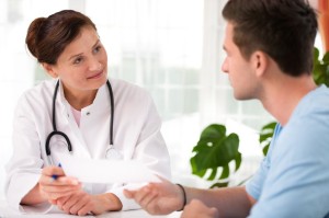 14904085 - doctor talking to her male patient at office