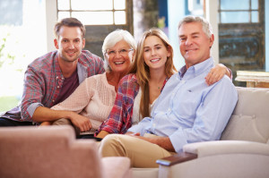 41461615 - family with adult children relaxing on sofa at home together