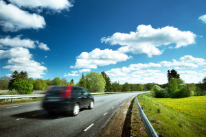 Car on asphalt road in beautiful spring day