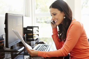 Hispanic woman working in home office