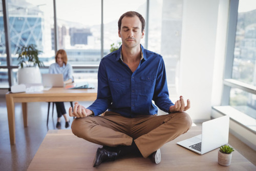 Executive meditating on desk