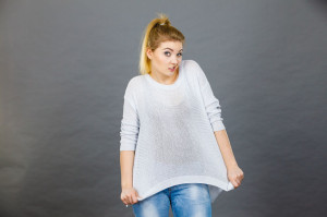 Woman wearing too big jumper